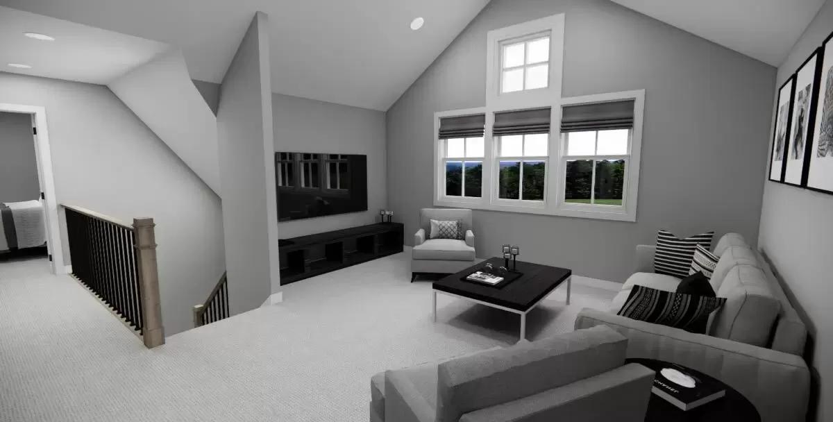 Loft with gray seats and a wall-mounted TV under a vaulted ceiling.