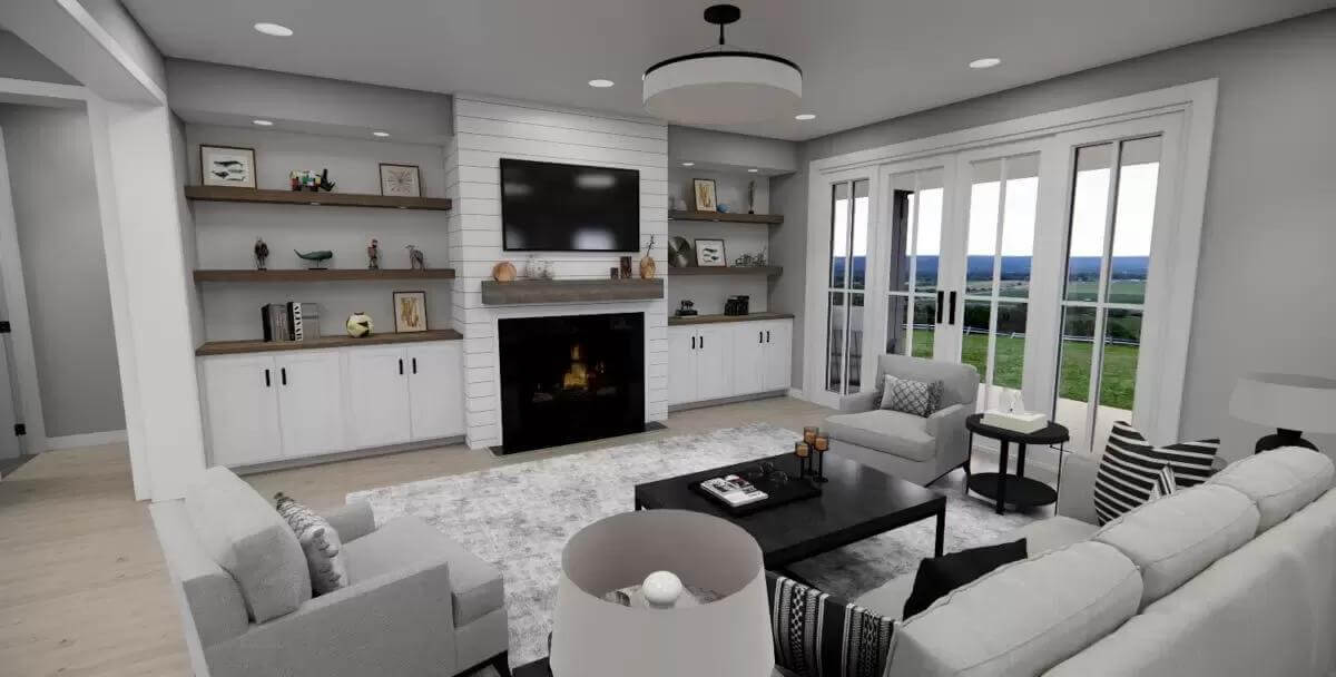Great room with gray seats and a fireplace flanked by built-in cabinets.