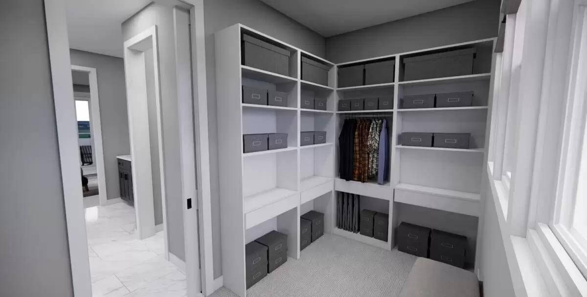Primary walk-in closet with ample storage and a carpeted floor.