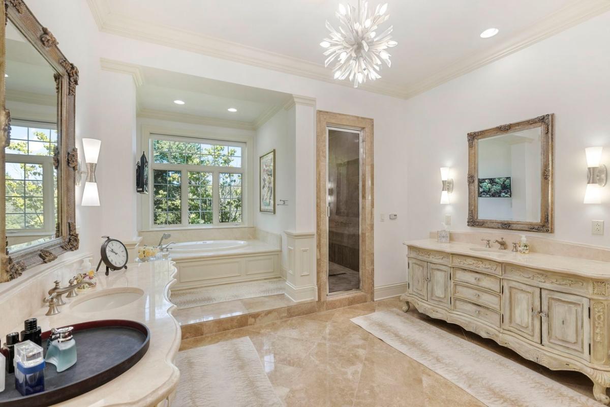 Bathroom with a custom-made vanity, a soaking tub and a walk-in shower.