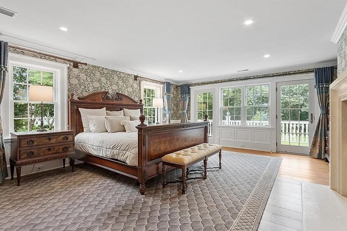 Bedroom with a large bed and glass windows.
