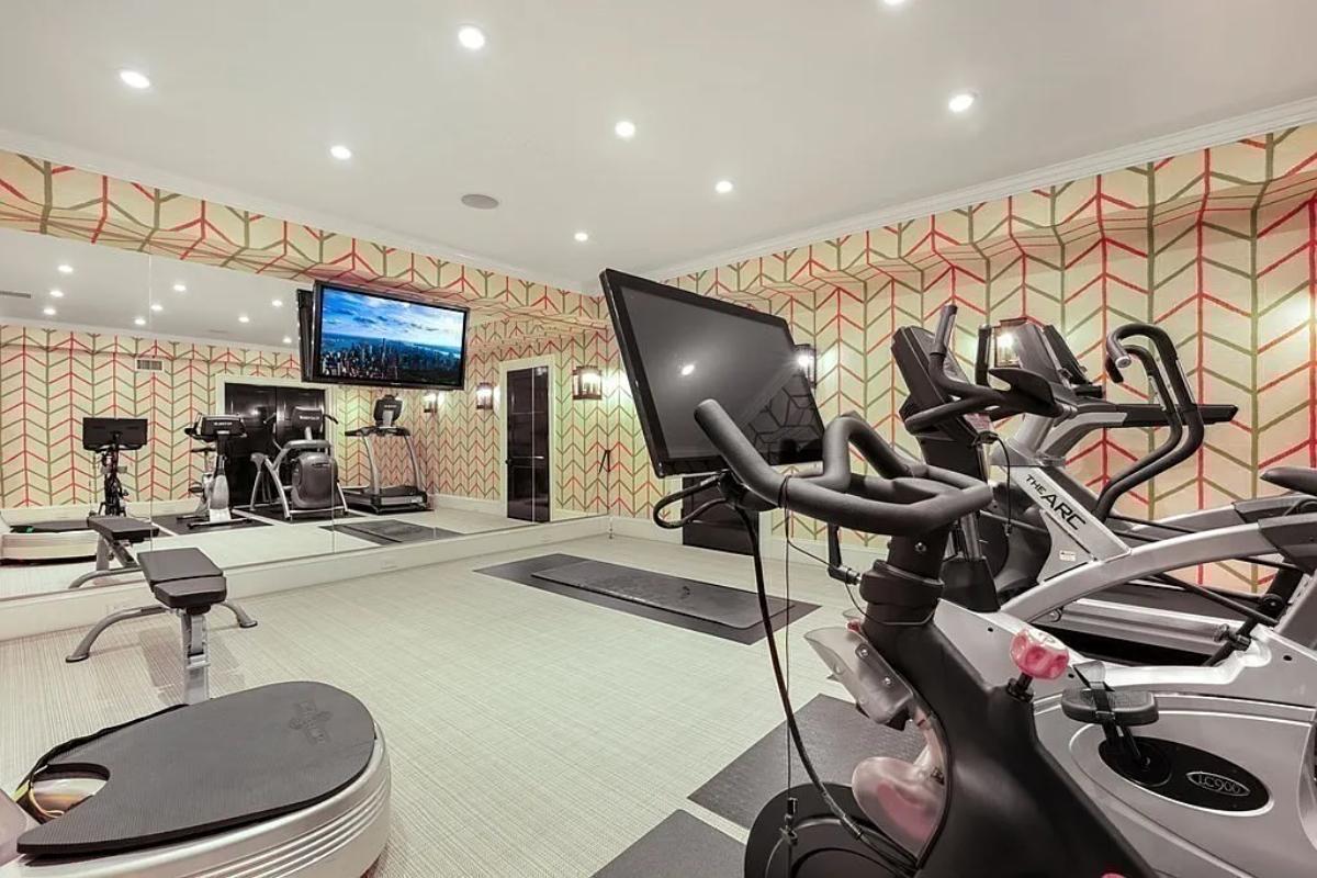 Home gym with large mirrors.