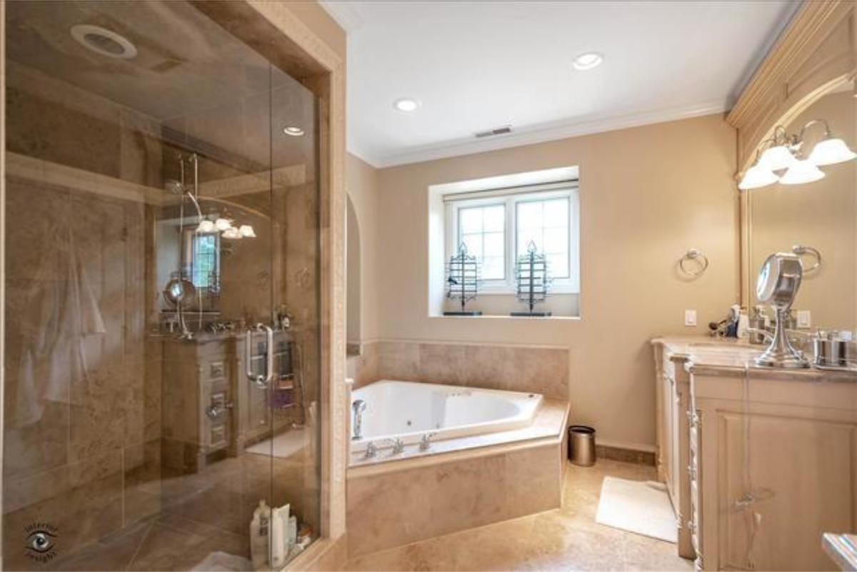 Bathroom with a custom-made vanity, a soaking tub and a walk-in shower.