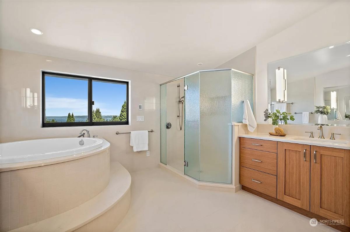 Bathroom with a custom-made vanity, a soaking tub and a walk-in shower.
