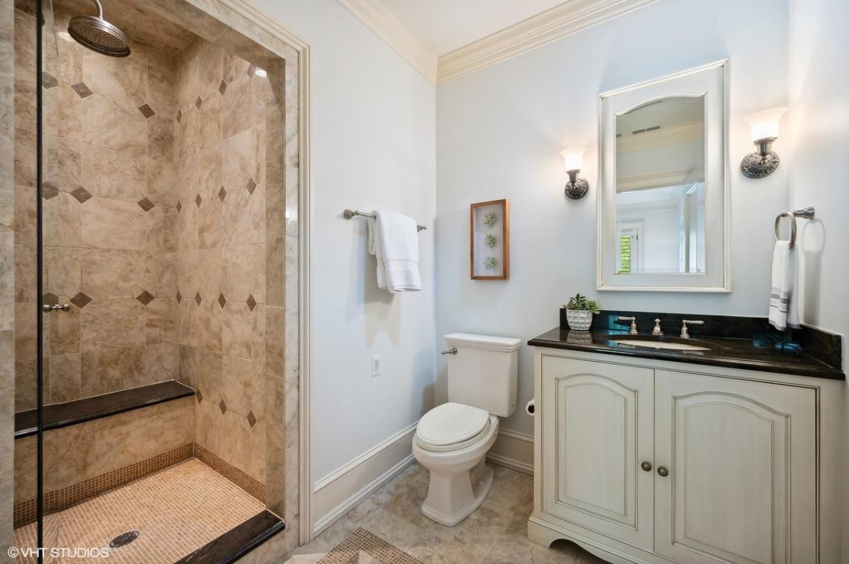 Bathroom with a sink, toilet and a walk-in shower.