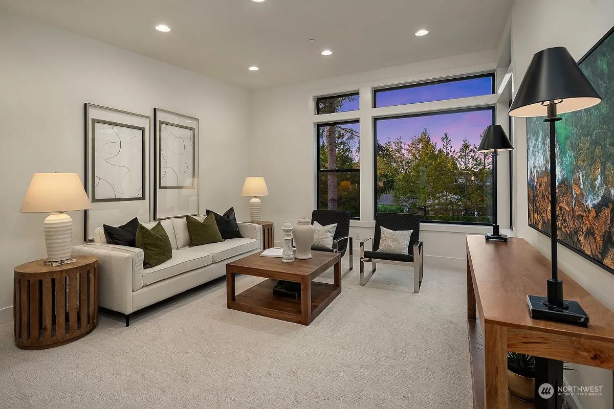 Living room with couches and carpet flooring.