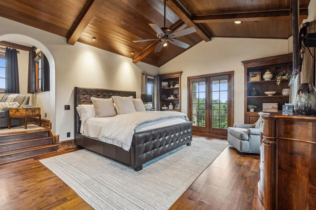 Bedroom with a large bed and hardwood floors.