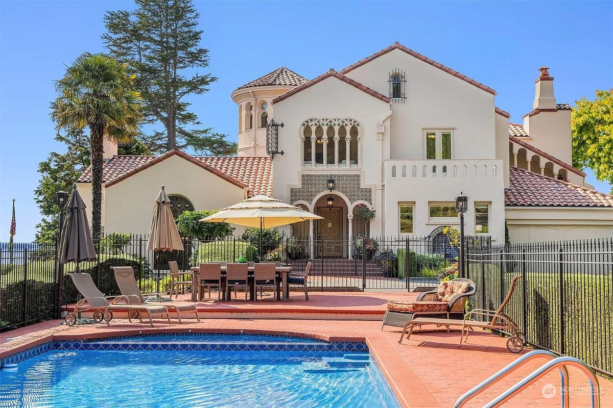 Front view of the mansion with a pool.