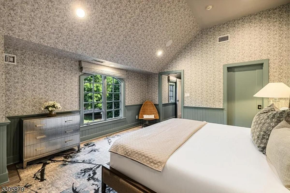 Bedroom with a large bed and glass windows.