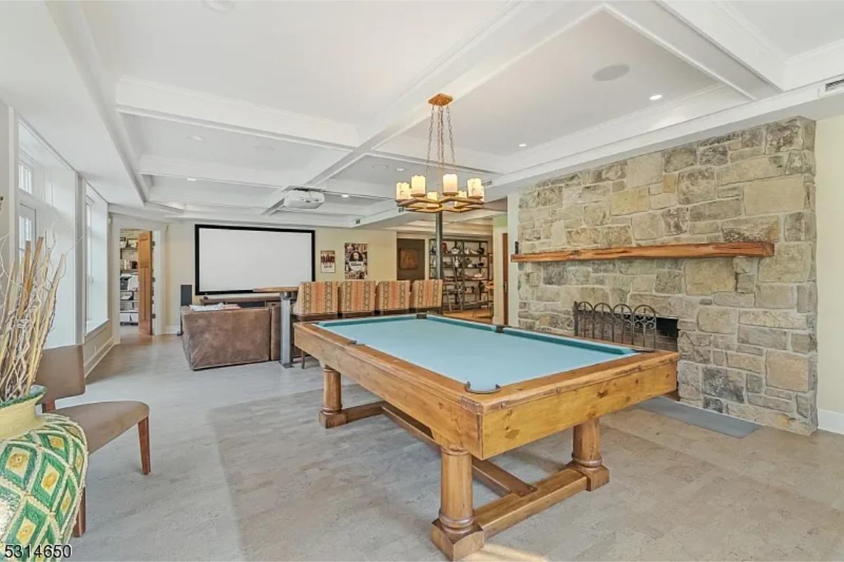 Recreation room with couches and a billiards table.