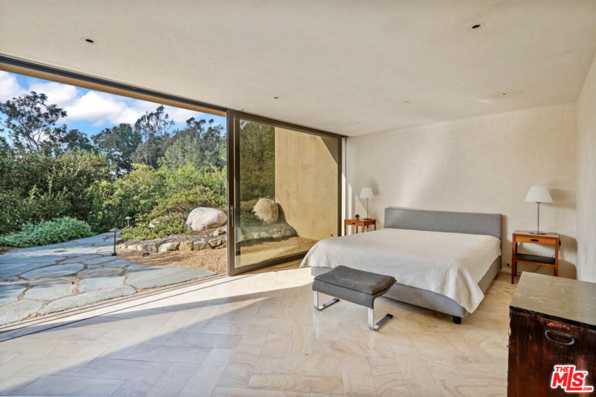 Bedroom with a large bed and sliding glass doors.