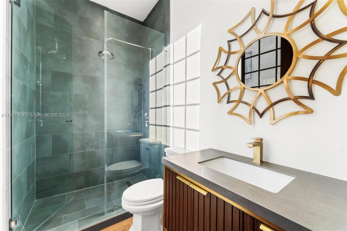 Bathroom with a sink, toilet and a walk-in shower.