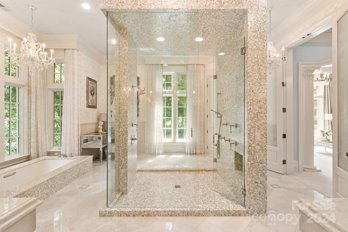 Bathroom with a chandelier and a walk-in shower.