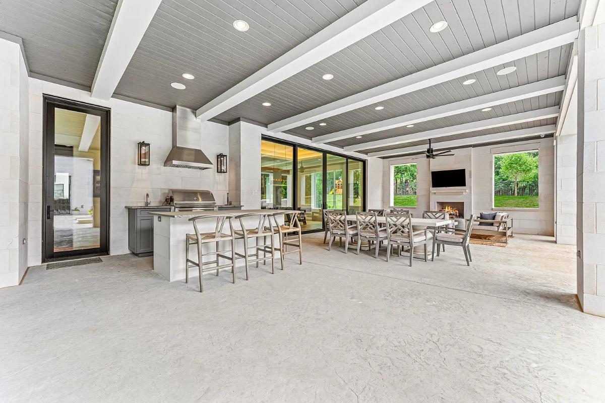 Outdoor space with expansive living area, dining area and a fully equipped outdoor kitchen.