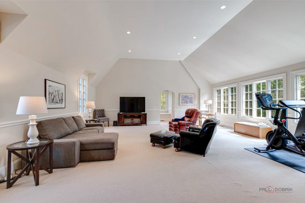 Recreation room with carpet flooring.
