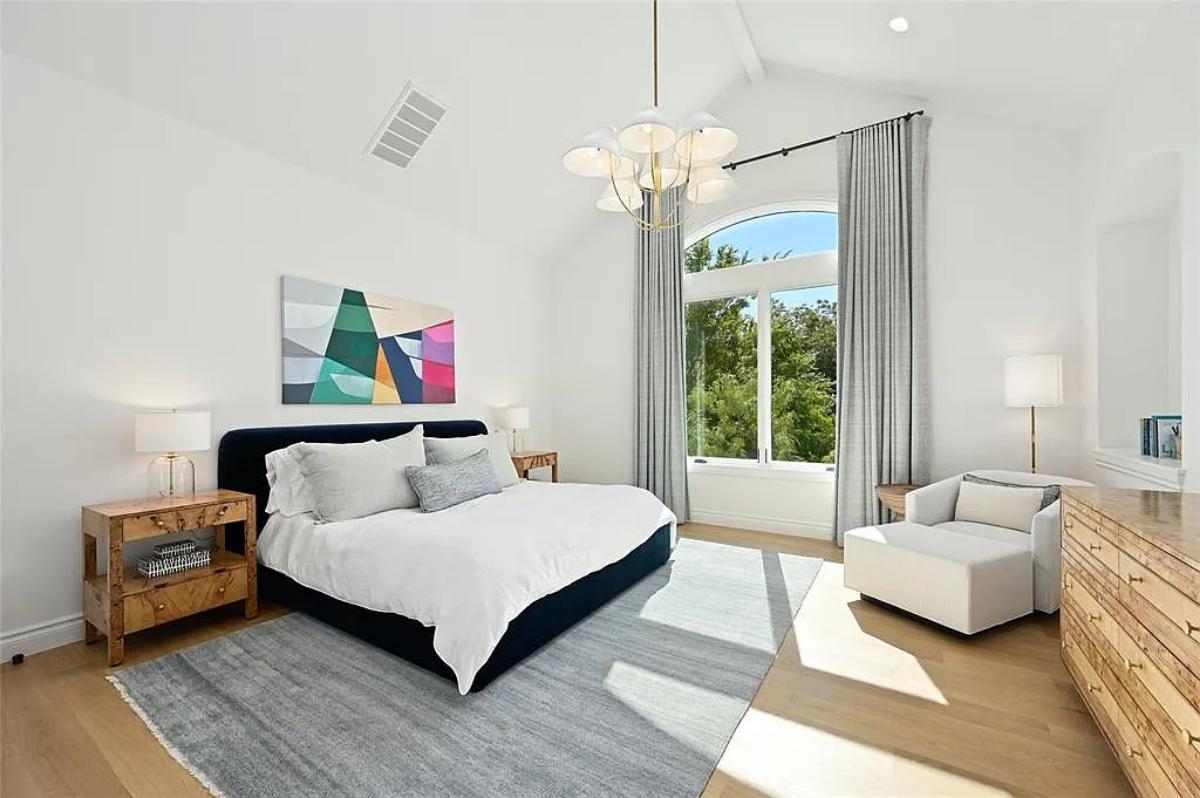 Bedroom with a large bed and hardwood floors.