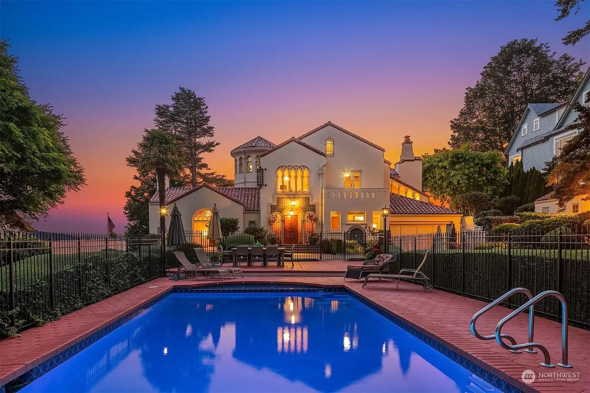 Front view of the mansion with a pool.