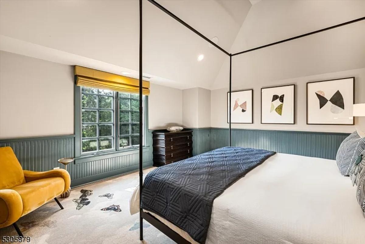 Bedroom with a large bed and glass windows.