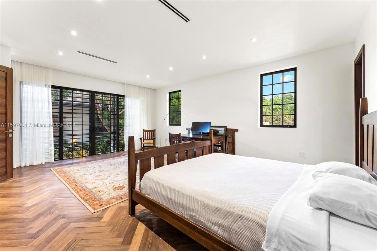 Bedroom with a large bed and hardwood floors.