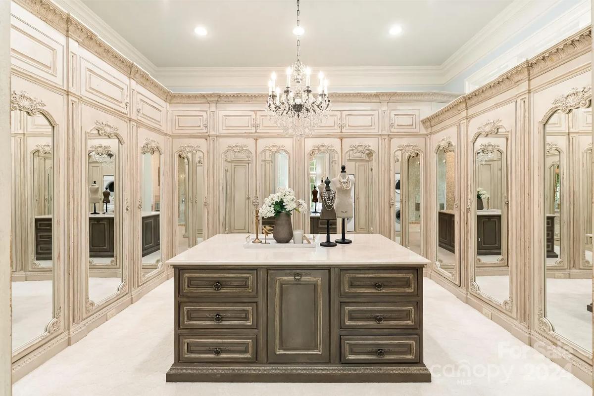 Walk-in closet with a chandelier.