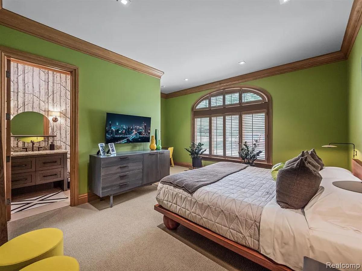 Bedroom with a large bed and carpet flooring.