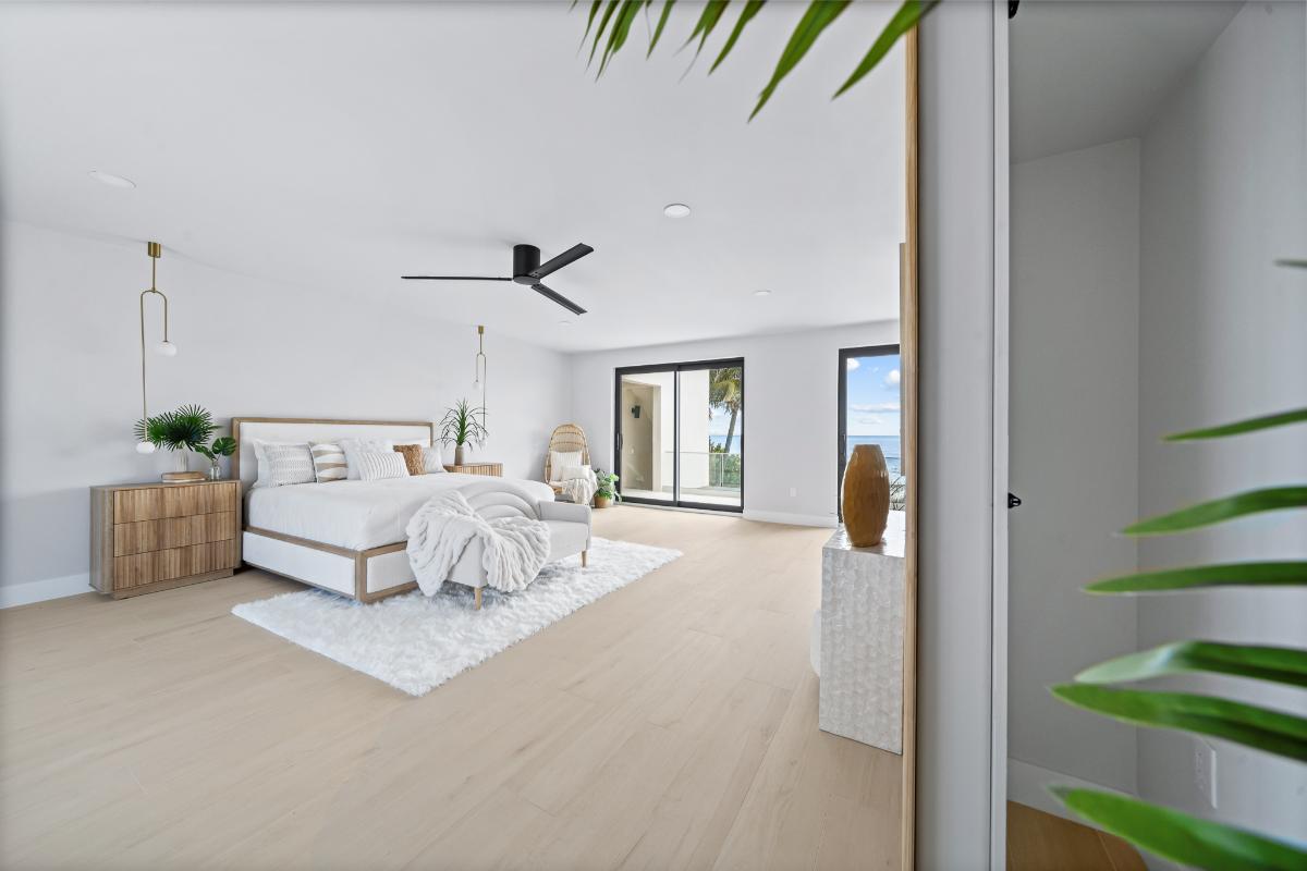 Bedroom with hardwood floors and sliding glass doors.