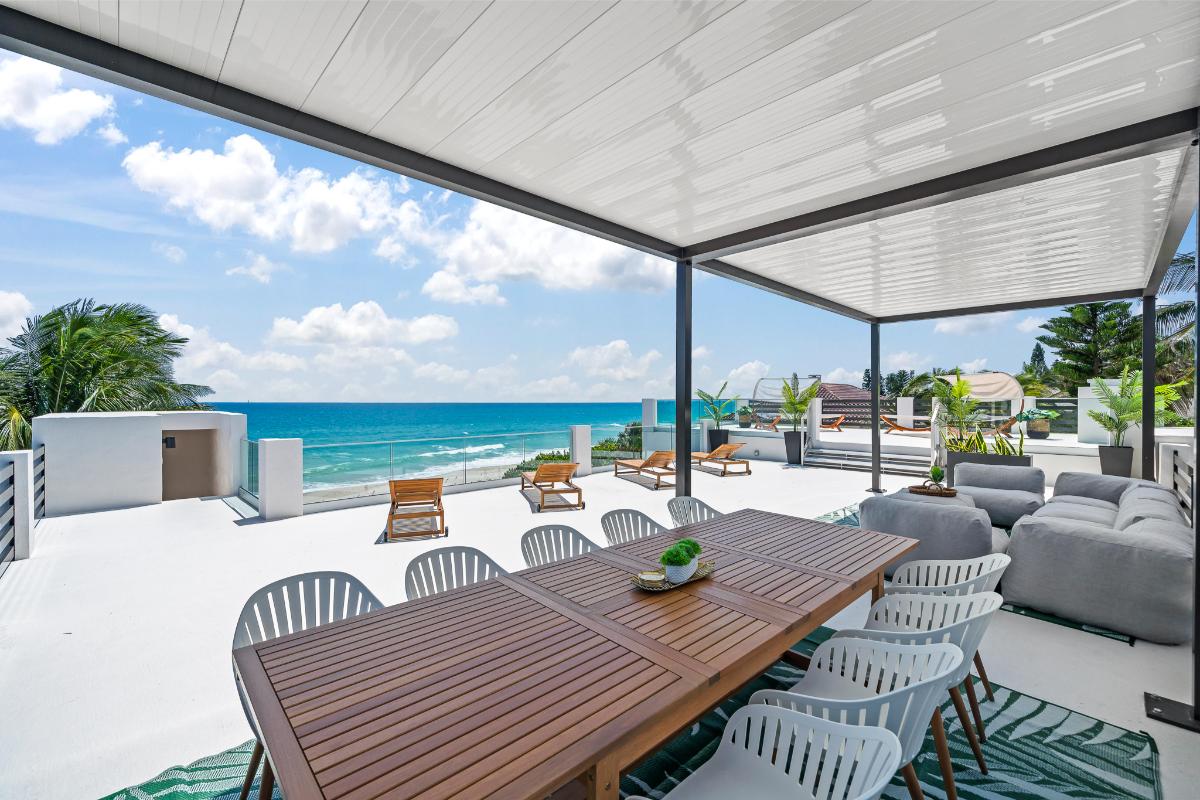 Rooftop deck with a dining area and a living space.