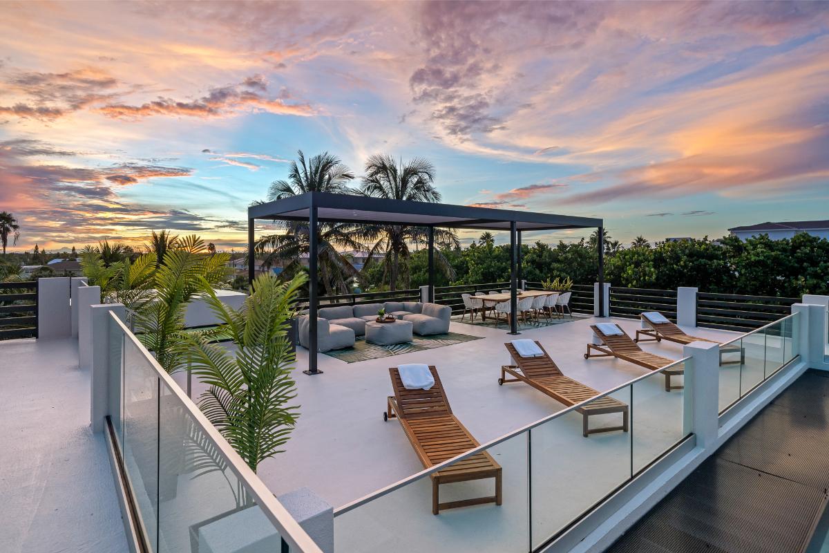 Rooftop deck with a dining area and a living space.