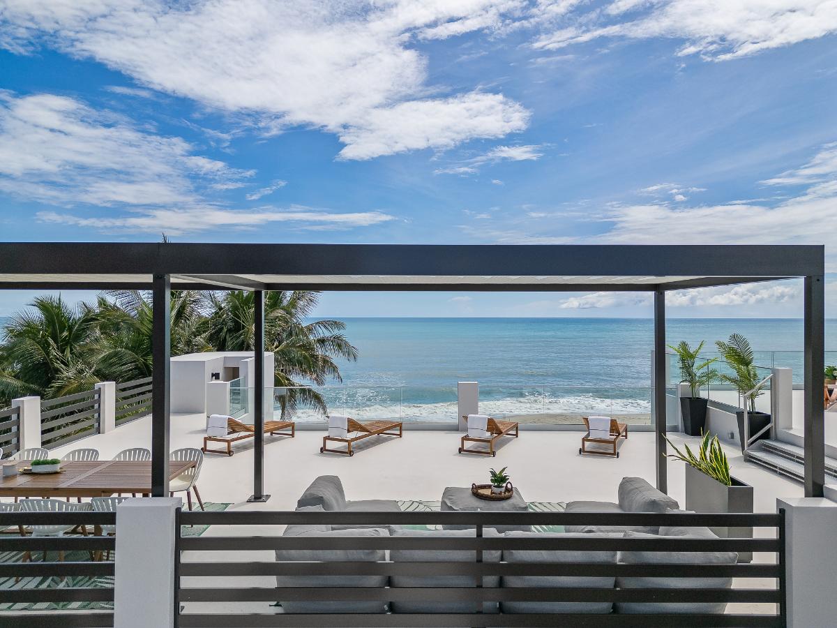 Rooftop deck with a dining area and a living space.