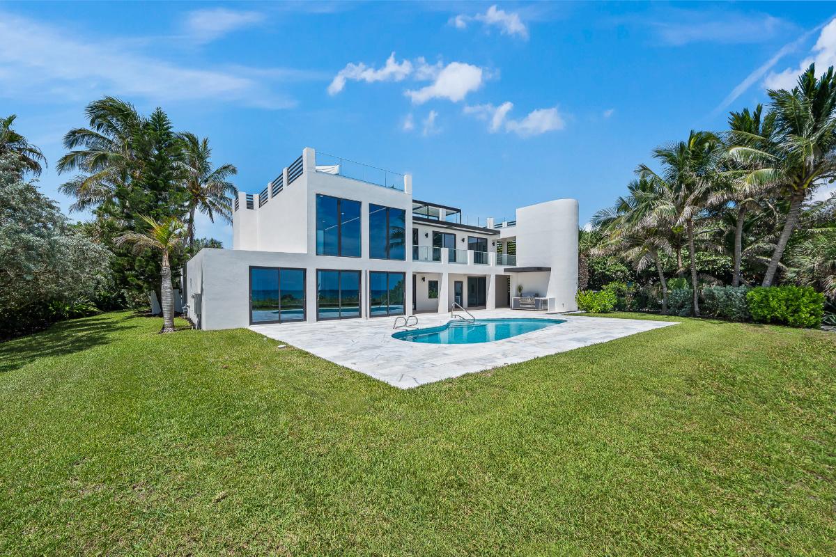 Rear view of the mansion with a pool.
