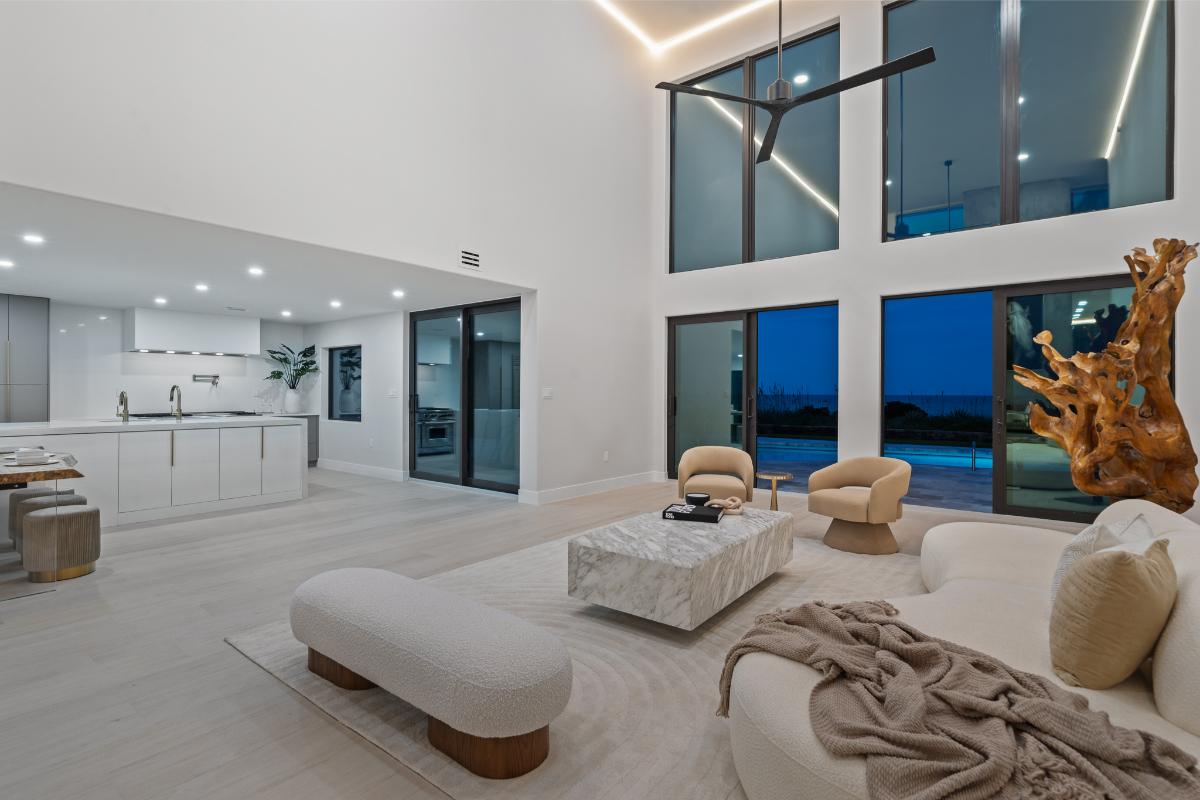Living room with high ceilings and sliding glass doors.