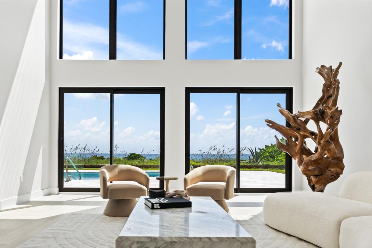 Living room with high ceilings and sliding glass doors.