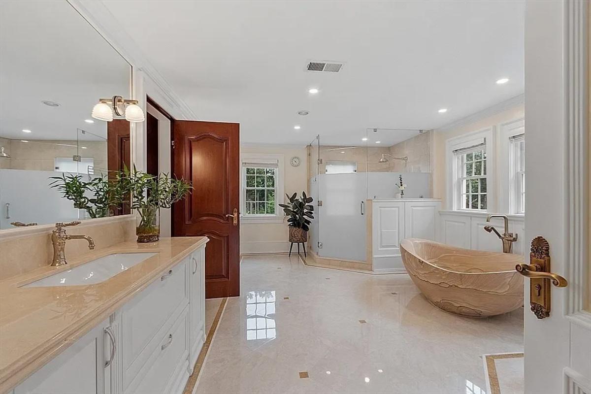 Bathroom with a custom-made vanity, a soaking tub and a walk-in shower.
