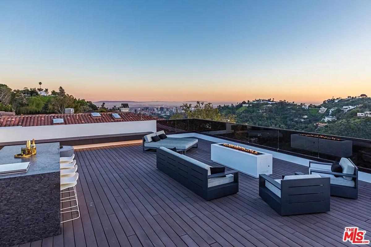 Rooftop deck with a bar and a fire pit.