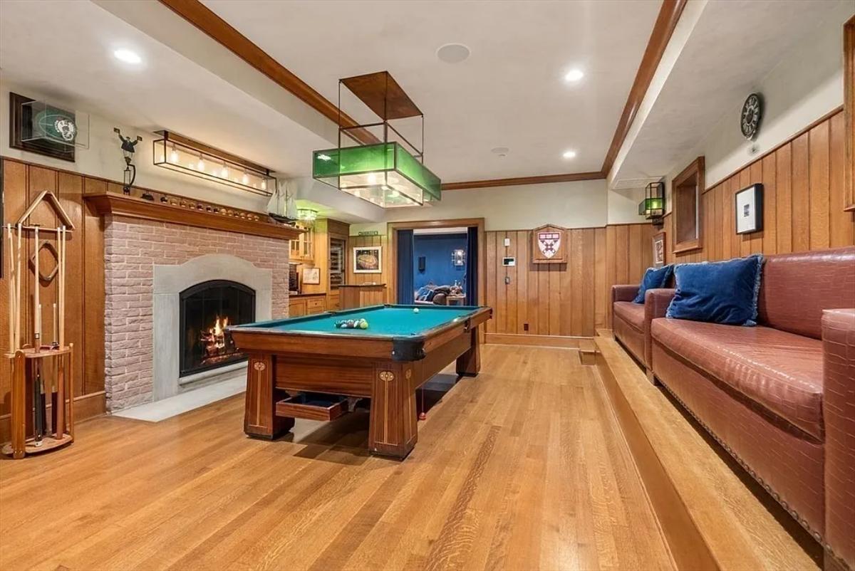 Billiards room with a fireplace.