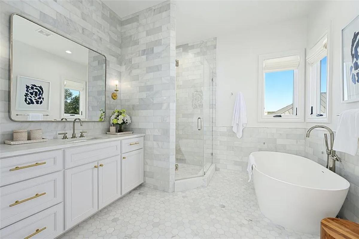 Bathroom with a custom-made vanity, a soaking tub and a walk-in shower.