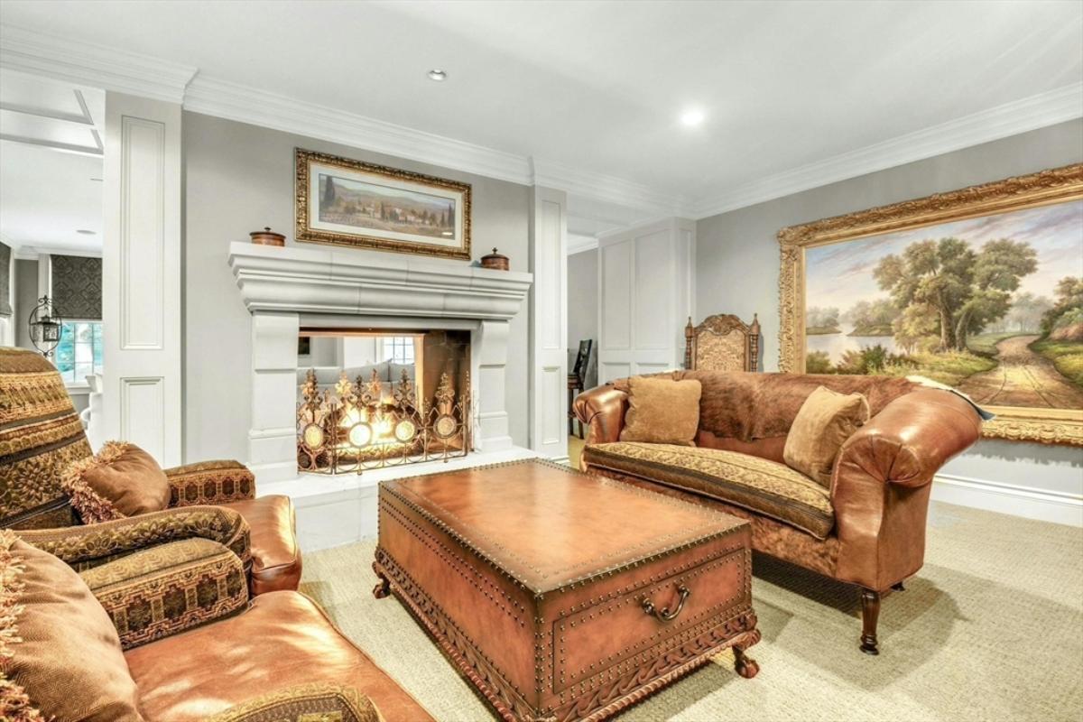 Living room with a fireplace and carpet flooring.