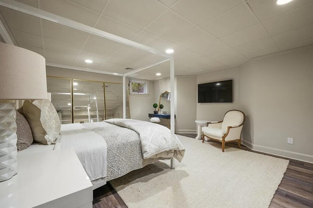 Bedroom with a large bed and hardwood flooring.