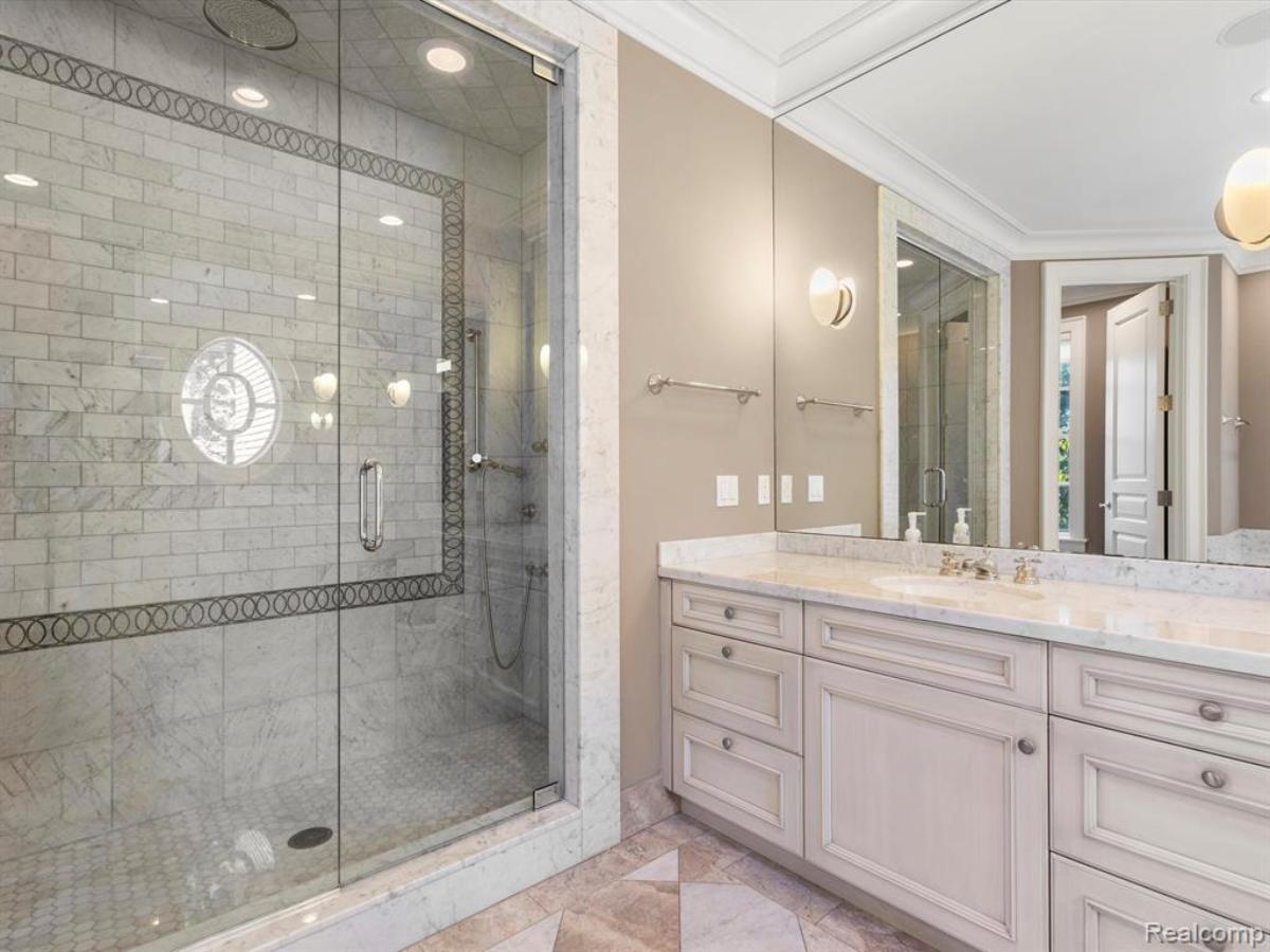 Bathroom with a custom-made vanity and a walk-in shower.