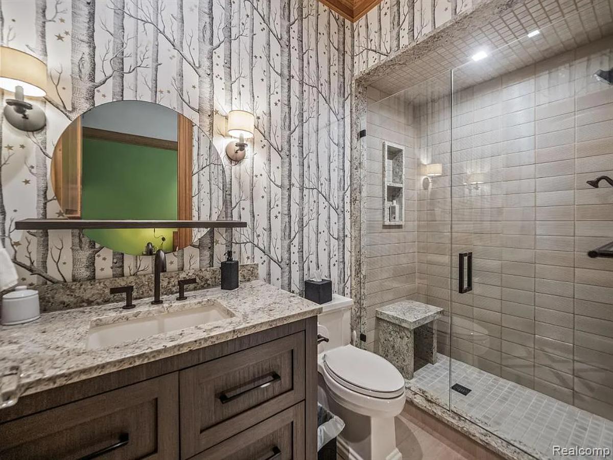 Bathroom with a sink, toilet and a walk-in shower.