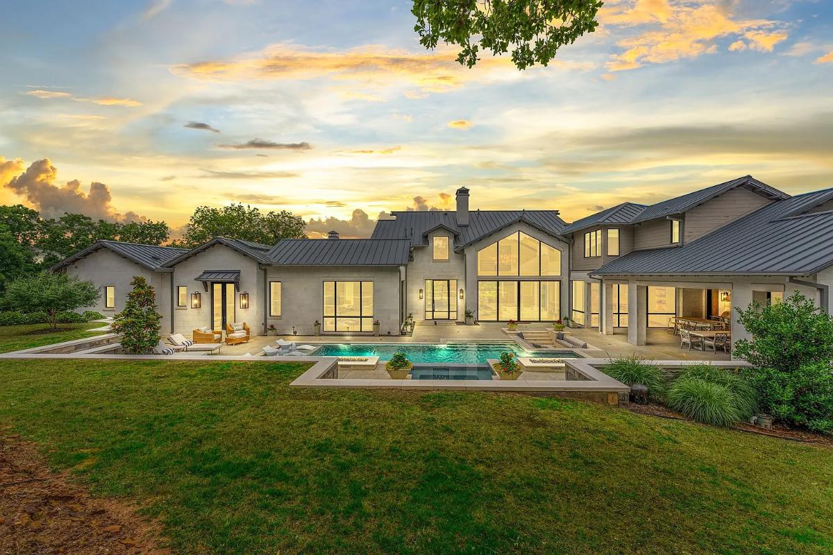 Rear view of the mansion with a pool.