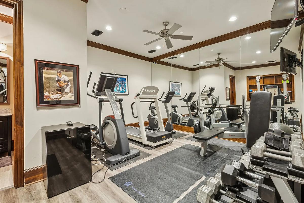 Home gym with large mirrors.