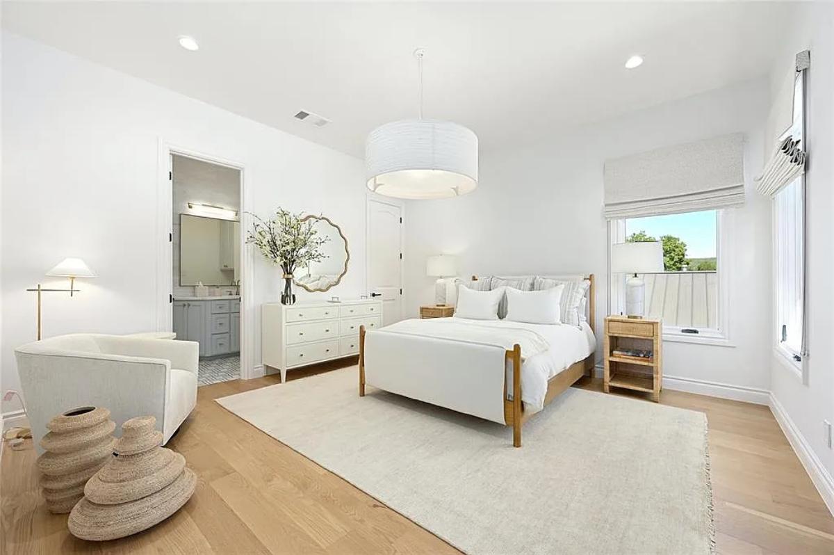 Bedroom with a large bed and hardwood floors.