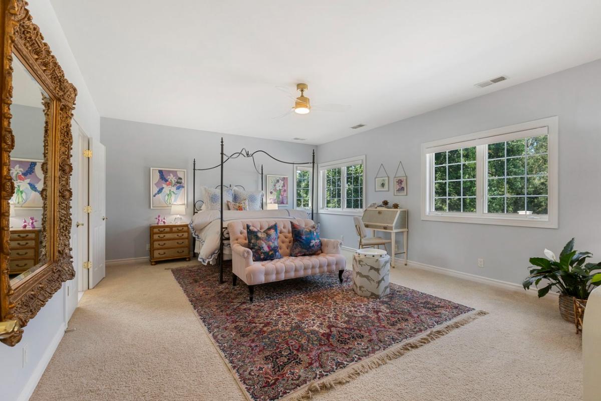 Bedroom with a large bed and carpet flooring.
