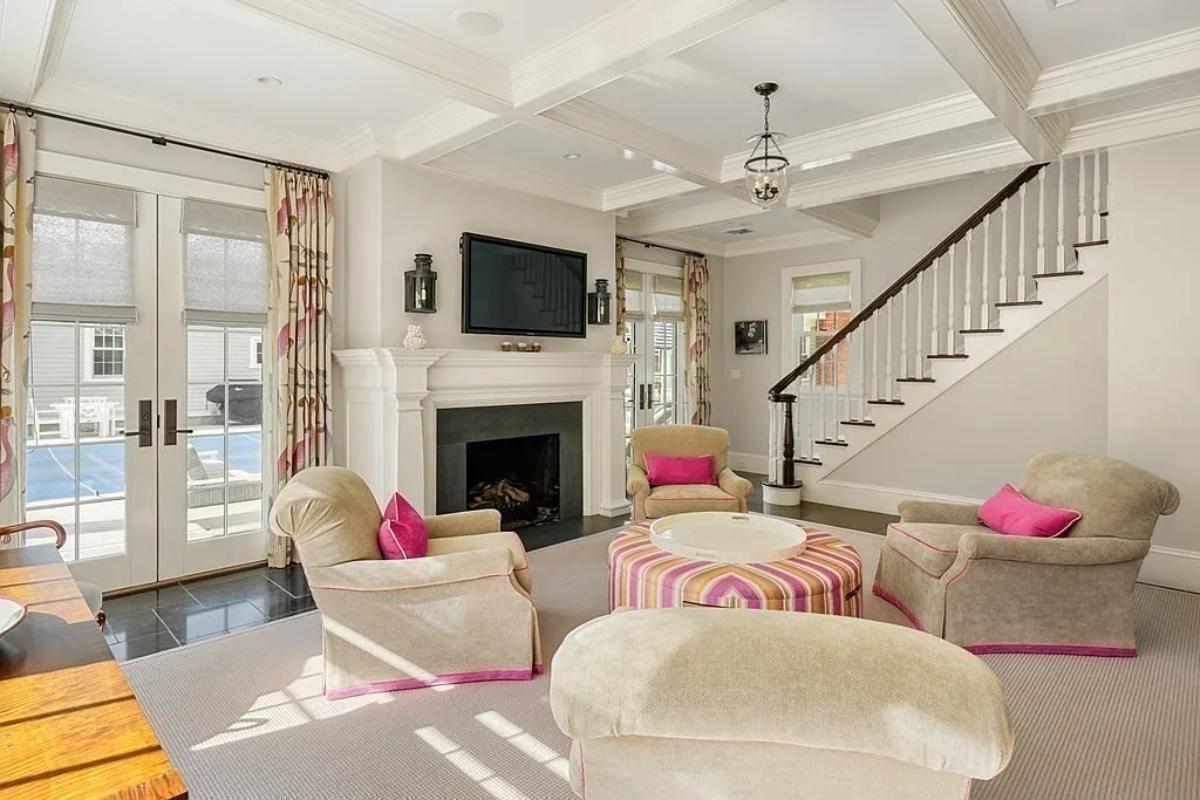 Living room with couches and a fireplace.