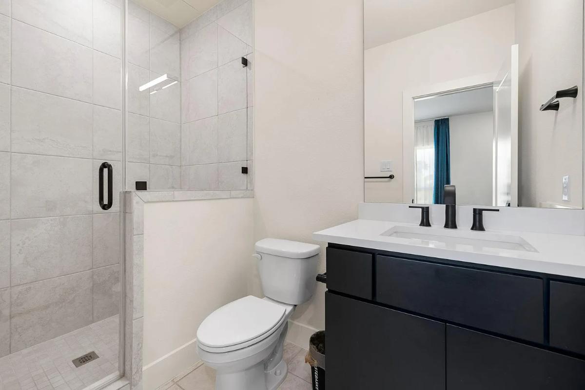 Bathroom with a sink, toilet and a walk-in shower.