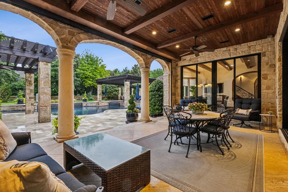Covered patio with a dining area and a living space.