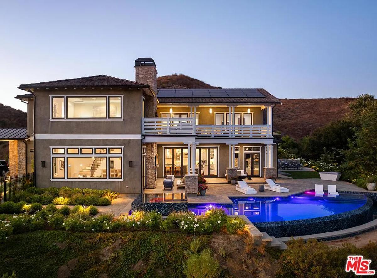 Rear view of the mansion with a pool.
