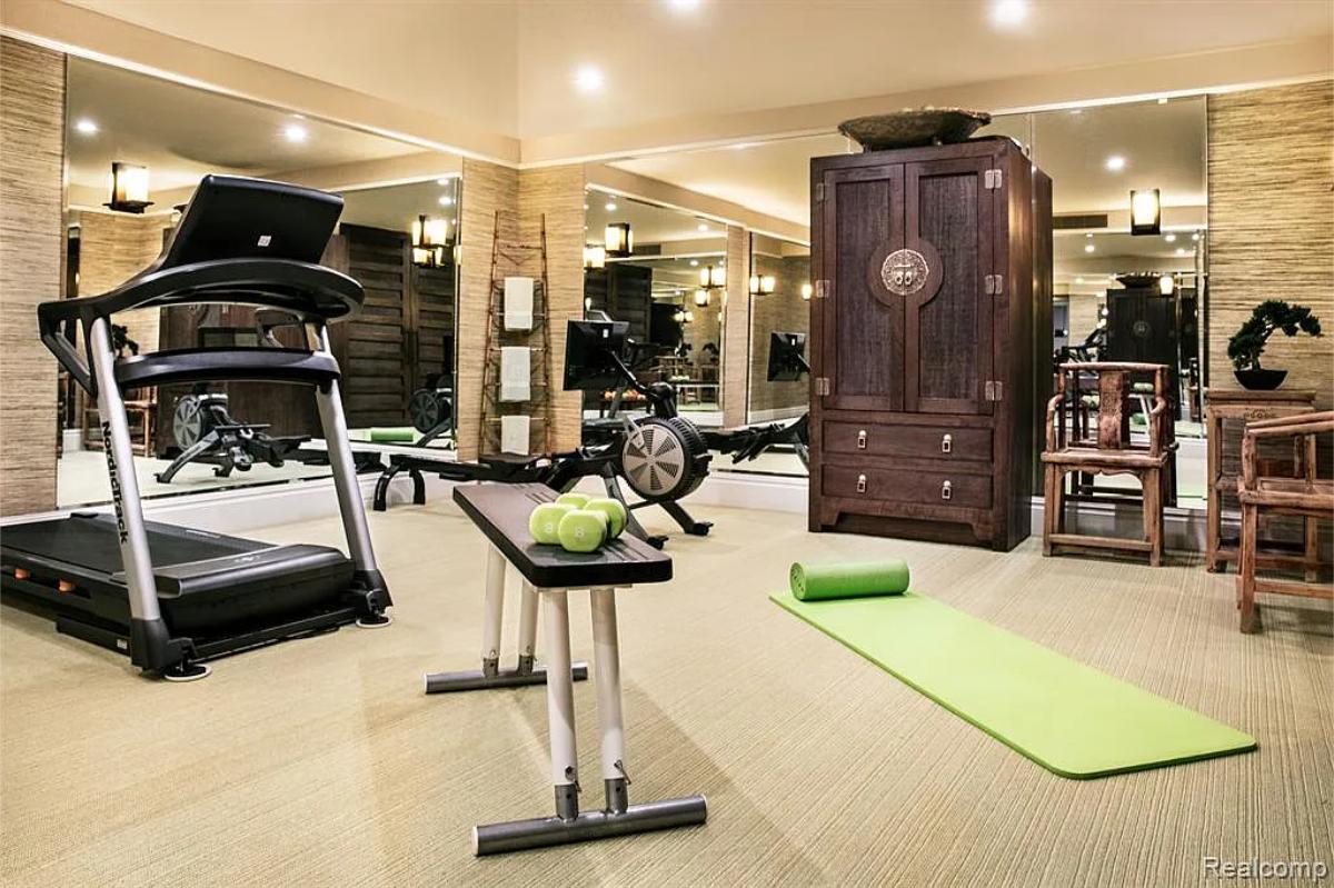 Home gym with large mirrors.