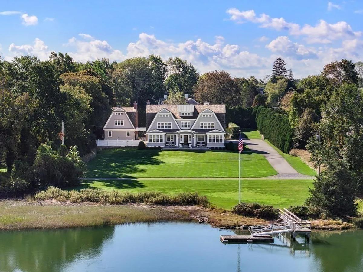 Rear view of the mansion with a boat dock.